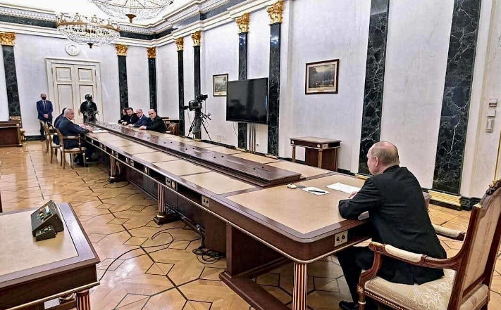 Vladimir Putin at the end of a very long conference table